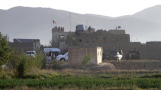Afghan security forces personnel on the roof of the main prison building after the attack