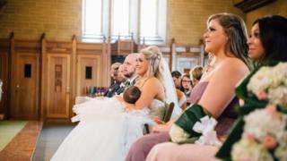 Christina Torino-Benton breastfeeds her child during her wedding ceremony.
