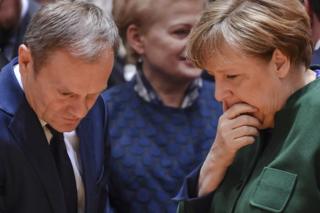 German Chancellor Angela Merkel, right, speaks to European Council President Donald Tusk, left, and Lithuanian President Dalia Grybauskaite, centre, during a round-table meeting at an EU summit in Brussels on Friday, 10 March