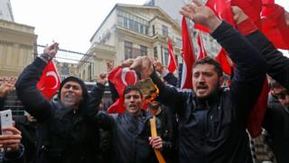 Supporters of Turkish President Recep Tayyip Erdogan burn a US dollar note as they shout slogans against the Netherlands in front of the Dutch Consulate in Istanbul, Turkey 12 March 2017