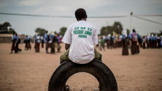 A supporter of the Gambian incumbent President Yahya Jammeh waits at a venue where an electoral meeting in Schur Alagie, The Gambia - Monday 28 November 2016