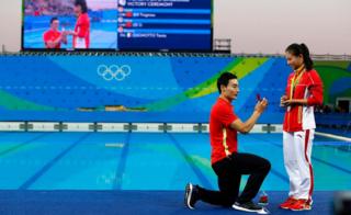 He Zi (R) of China receives a marriage proposal from Chinese diver Ki Qin (L) after winning the silver medal in the women"s 3m Springboard final of the Rio 2016 Olympic Games