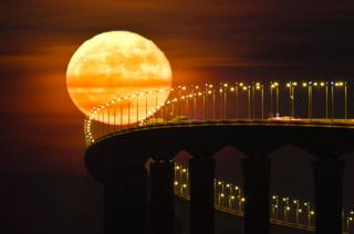 A full moon rising over the Re Island Bridge in Rivedoux
