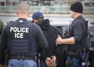 US Immigration and Customs Enforcement (ICE) agents detain a suspect during an enforcement operation on 7 February, 2017 in Los Angeles.