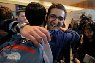 Behnam Partopour, a Worcester Polytechnic Institute (WPI) student from Iran, is greeted by friends at Logan Airport after he cleared U.S. customs and immigration on an F1 student visa in Boston, Massachusetts, 3 February