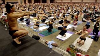 In this Sept. 27, 2003, file photo, Bikram Choudhury, front, founder of the Yoga College of India and creator and producer of Yoga Expo 2003, leads what organizers hope will be the world's largest yoga class at the Expo at the Los Angeles Convention Centre.
