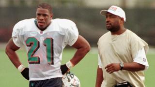 This file photo taken on December 2, 1997 shows Miami Dolphins" new running back Lawrence Phillips (L) walking off the practice field