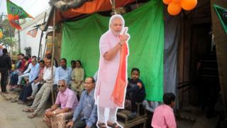 Supporters of India's Bharatiya Janata Party (BJP) wait to catch a glimpse of Indian Prime Minister Narendra Modi and BJP Leader during a roadshow in support of state assembly election party candidates in Varanasi