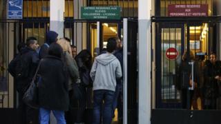 Students enter a high school in Paris