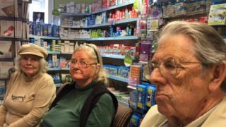 Worried elderly patients at a pharmacy
