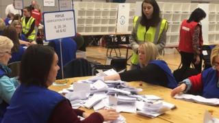 Polling staff begin counting at the Foyle Arena in Londonderry