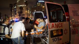 A wounded man is moved onto an ambulance after a stabbing attack in Jaffa, Israel (8 March 2016)