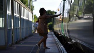 Woman boarding train at station