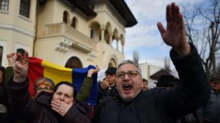 Romanian protesters outside the presidential residence, Cotroceni Palace, in Bucharest on 5 February