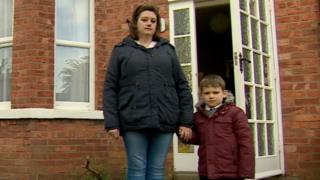 Emma Percy and her son outside her house