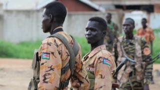 South Sudanese policemen and soldiers stand guard along a street following renewed fighting in South Sudan"s capital Juba, July 10, 2016