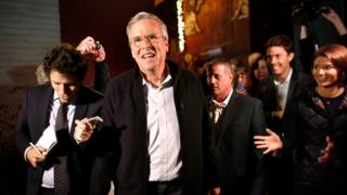 Republican presidential candidate, former Florida Gov. Jeb Bush, centre left, walks with members of the media and supporters as he departs a campaign event held in a barn belonging to former .S. Sen. Scott Brown, R-Mass., Tuesday, Nov. 3, 2015, in Rye, N.H