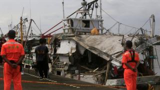 This handout photo taken and released by Taiwan's Central News Agency (CNA) shows a damaged fishing boat at a harbour in southern Tainan, on 1 July