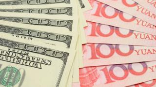 US dollars and Chinese yuan notes