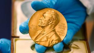 A national library employee shows the gold Nobel Prize medal awarded to the late novelist Gabriel Garcia Marquez, in Bogota, Colombia