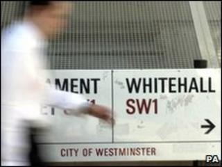 Man passes Whitehall street sign