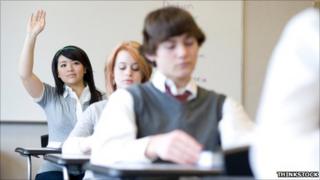 Girl with hand up in class