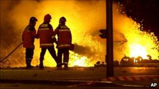 Spanish fireman extinguish burning cars after a car bomb exploded in the Basque regional capital of Vitoria, Spain in the early hours of Monday, Oct 1, 2001