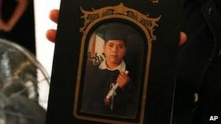 Family member holds a photograph of Alejandro Leon Castellanos, 15, shot dead with his father at a military checkpoint