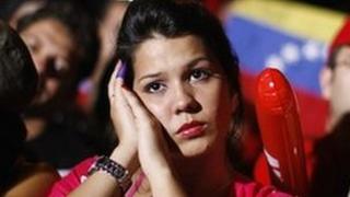 Supporters of Venezuela's President Hugo Chavez listen to the electoral results in Caracas early on Monday morning