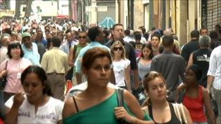 Brazilians walk along a main street in Sao Paulo, September 2010