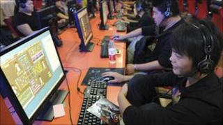 A teenager uses a computer at an internet cafe in Hefei, Anhui province, on 26 Sept 2010.