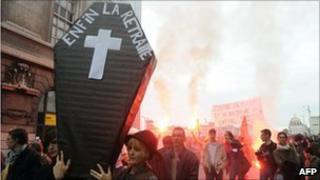 Demonstrators in Lyon, central France, carry a mock coffin marked "Finally retiring", 6 November