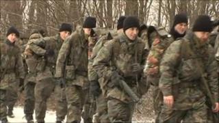 Swiss army recruits marching in forest