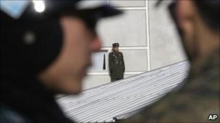 A North Korean soldier, centre watches southern soldiers at the border village of Panmunjom, 19/01