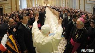 Pope Benedict XVI waves at the end of a special audience with members of the Italian Police