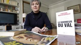 Fabienne Boulin-Burgeat, Robert Boulin's daughter, poses at her home with her book about his death, The Sleeper In The Valley, 25 January 2011