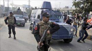 An armoured car carrying Raymond Davis leaves a court in Lahore on 11 February 2011