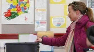 A woman votes in Castlebar, County Mayo, Irish Republic, 25 February
