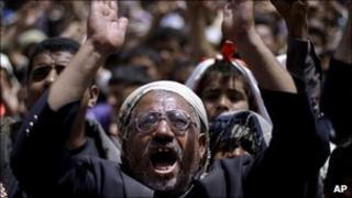 Anti-government protesters react during a demonstration in Sanaa, Yemen, 14 March 2011