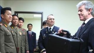 North Korean officials hand over remains of pilot to British ambassador Peter Hughes