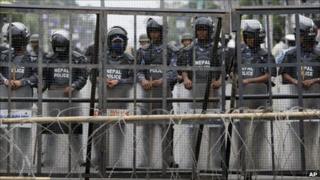 Nepalese police guard the restricted area around the constitutional assembly