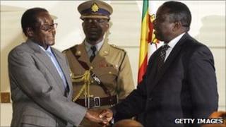 Robert Mugabe and Morgan Tsvangirai shake hands (archive photo)