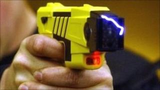 Police officer demonstrates a Taser gun