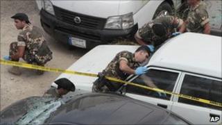 Lebanese soldiers investigate the bomb scene in Beirut on 11 August 2011