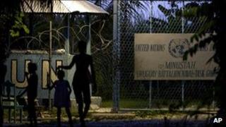 People walk in front of the UN base in Haiti where the alleged abuse took place