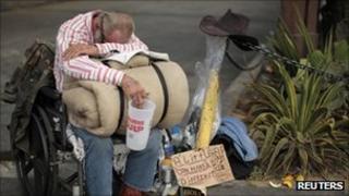 A homeless man begging for money in Los Angeles on 22 August