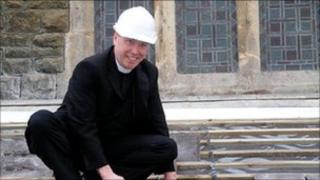 Rev Paul Davies, Archdeacon of Bangor, lending a hand during renovations at a church in Burry Port