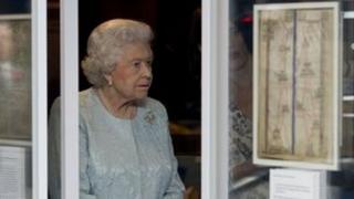 The Queen looks at some exhibits at the