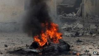 A car burns shortly after it exploded in Mogadishu