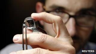 Vendor inspects a diamond (Antwerp January 31, 2012)
